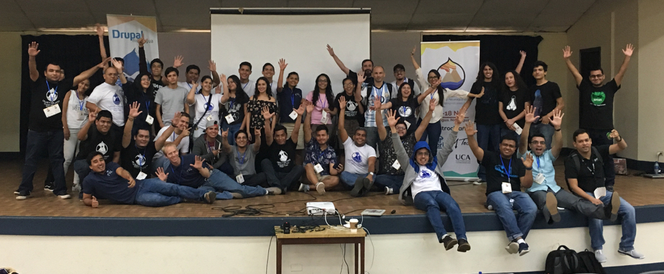 Group photo of attendees raising up their arms in excitement.